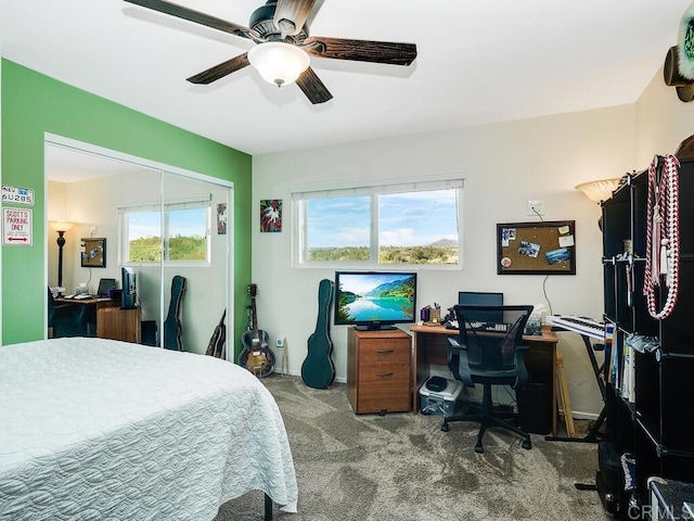 carpeted bedroom featuring a closet and ceiling fan