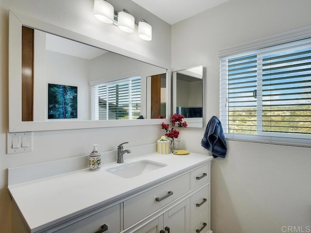 bathroom with a healthy amount of sunlight and vanity