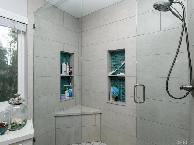 bathroom with a shower with door