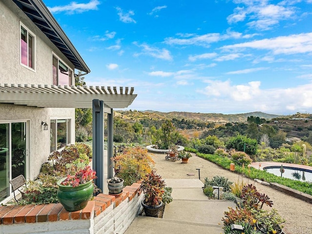 view of yard with a mountain view, a pergola, and a patio