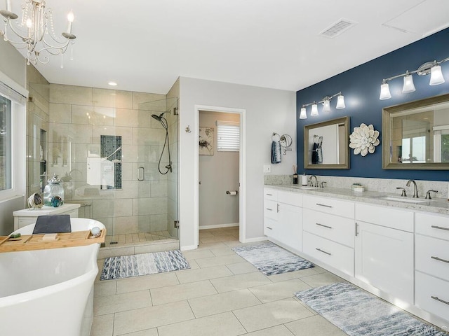 bathroom featuring vanity, tile patterned floors, plus walk in shower, and a chandelier