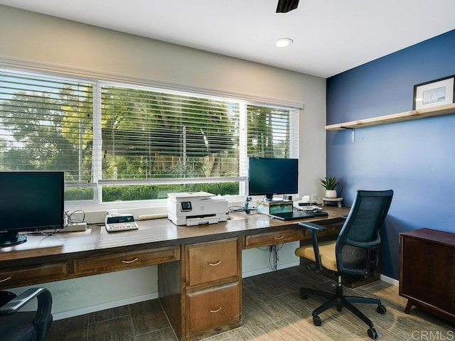 home office with dark hardwood / wood-style floors