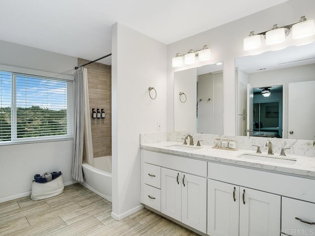 bathroom with vanity, shower / bathtub combination with curtain, and ceiling fan