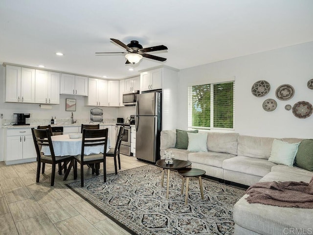 living room with sink and ceiling fan