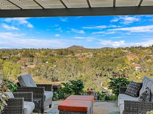 view of patio featuring a mountain view, an outdoor hangout area, and a pergola