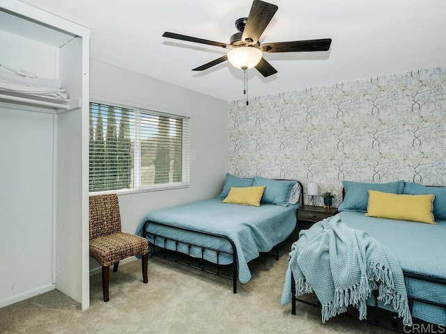 bedroom featuring ceiling fan and light colored carpet