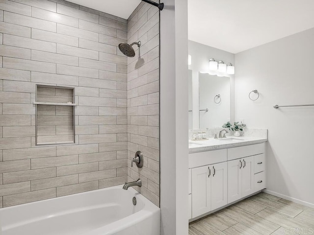 bathroom with vanity and tiled shower / bath combo