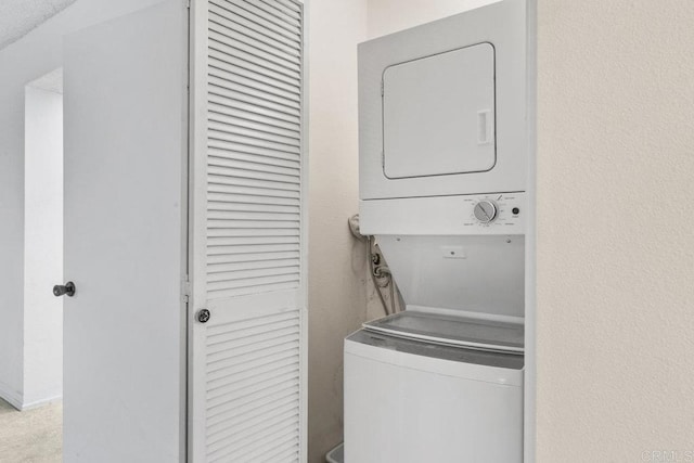 laundry area with stacked washing maching and dryer