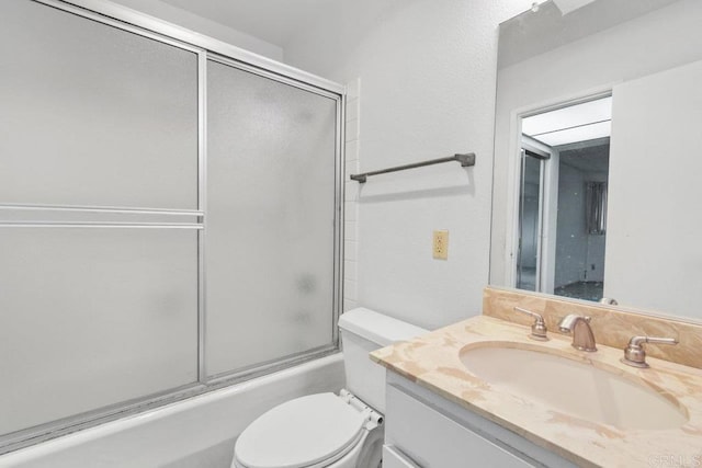 full bathroom with vanity, toilet, and combined bath / shower with glass door