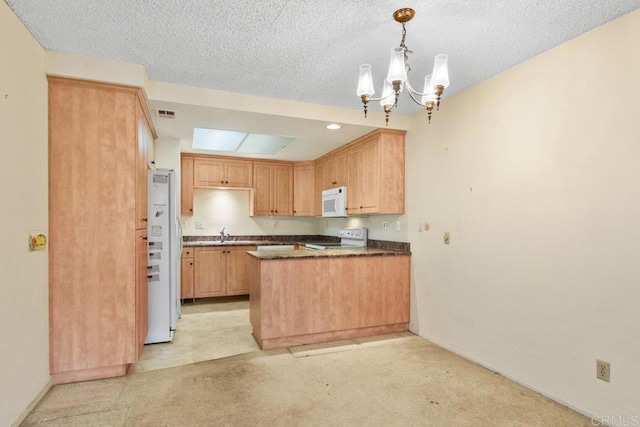 kitchen featuring a chandelier, hanging light fixtures, white appliances, light brown cabinets, and a textured ceiling