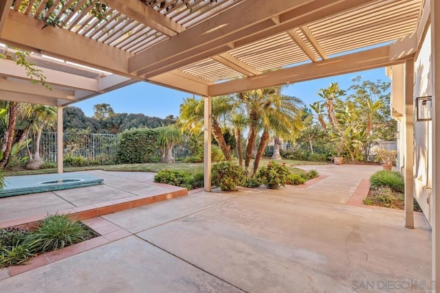 view of patio with an outdoor hot tub and a pergola