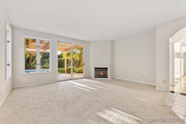 unfurnished living room featuring light colored carpet