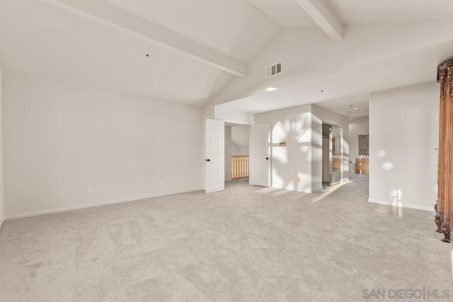 unfurnished room with beamed ceiling, light carpet, and high vaulted ceiling