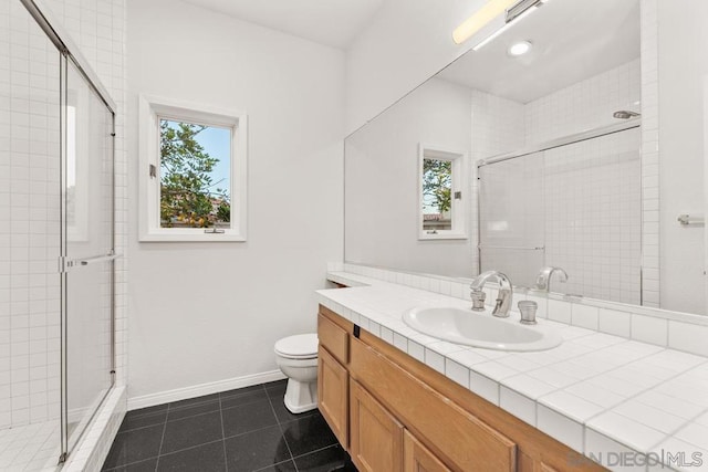 bathroom featuring walk in shower, tile patterned floors, toilet, and vanity