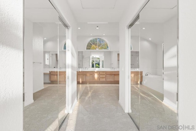 bathroom featuring a towering ceiling and vanity