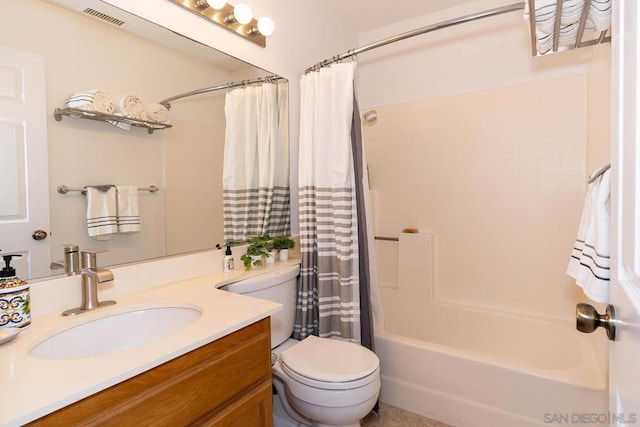 full bathroom with vanity, shower / tub combo with curtain, and toilet