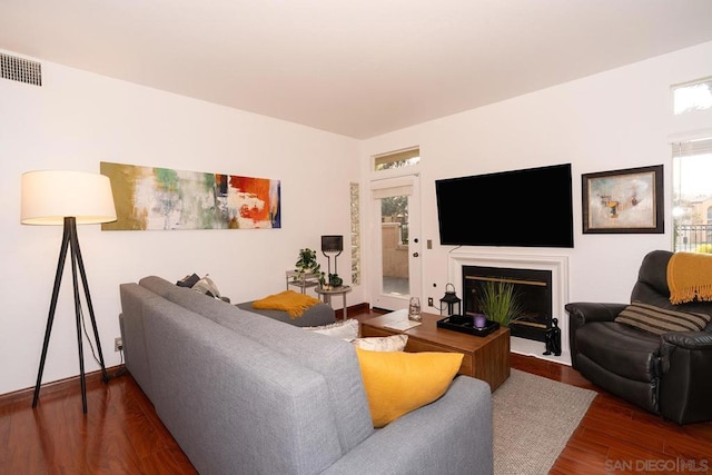 living room with dark hardwood / wood-style flooring