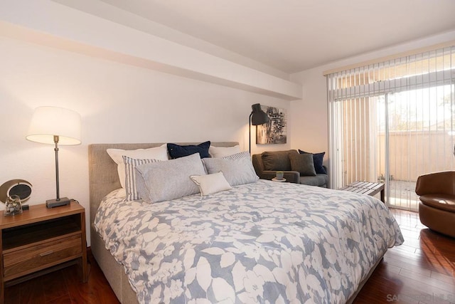 bedroom featuring dark wood-type flooring and access to exterior