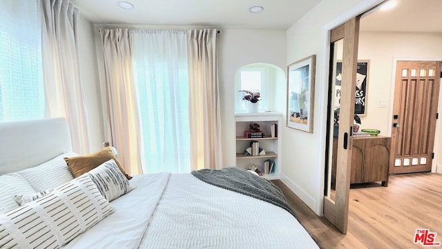 bedroom with hardwood / wood-style floors