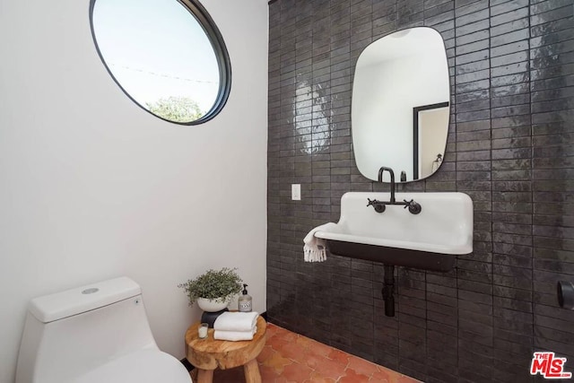 bathroom with tile patterned flooring, sink, and toilet