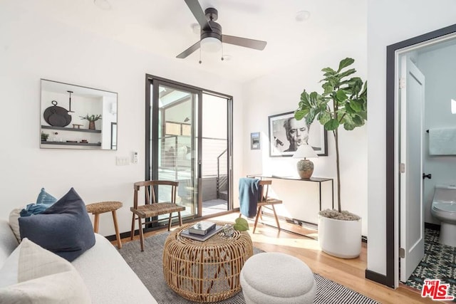 living area with hardwood / wood-style floors and ceiling fan