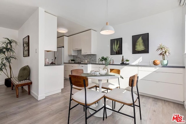 dining space with light hardwood / wood-style floors