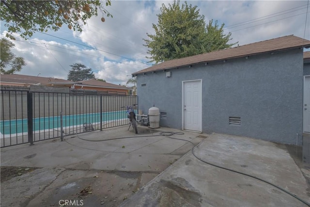 view of patio / terrace with a fenced in pool