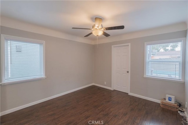 unfurnished room with dark wood-type flooring and ceiling fan