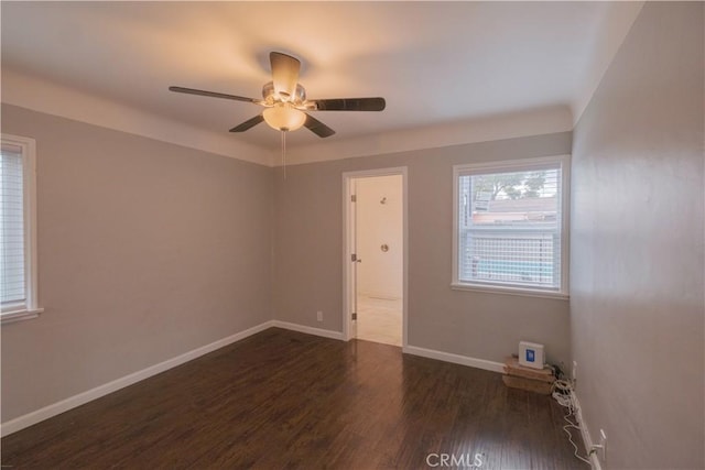 spare room with ceiling fan and dark hardwood / wood-style floors