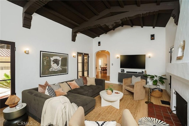 living room featuring hardwood / wood-style flooring, high vaulted ceiling, wooden ceiling, and beam ceiling