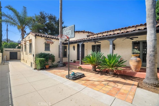 mediterranean / spanish-style house with a patio and ceiling fan