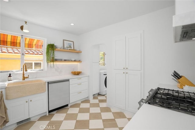 kitchen featuring white cabinetry, a healthy amount of sunlight, dishwashing machine, and sink