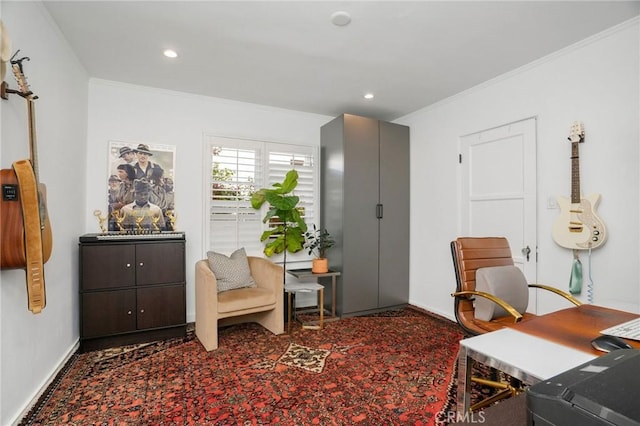 sitting room featuring crown molding and carpet floors