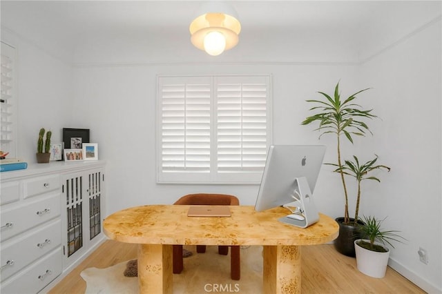 office with light wood-type flooring