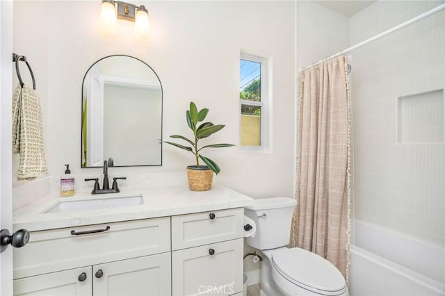 full bathroom with vanity, shower / bath combo, and toilet