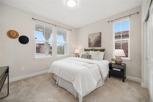 bedroom featuring light colored carpet