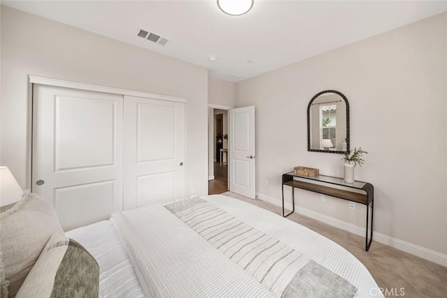 bedroom featuring light carpet and a closet