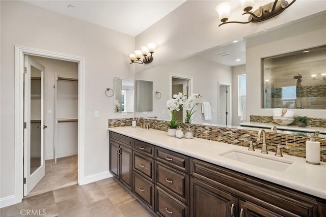 bathroom with vanity, a chandelier, and walk in shower