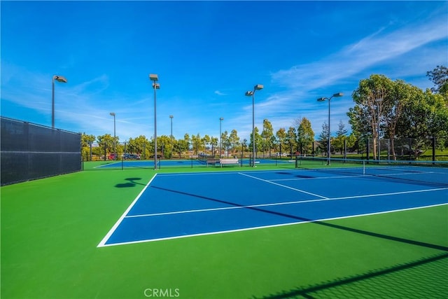 view of tennis court featuring basketball court