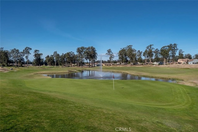 view of property's community featuring a yard and a water view