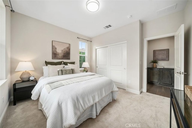 carpeted bedroom featuring a closet