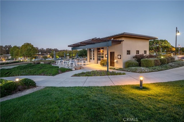 view of community with a pergola, a yard, and a patio area