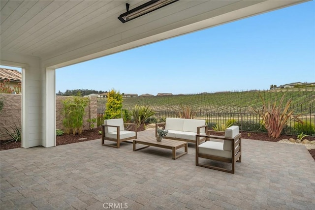 view of patio with an outdoor hangout area and a rural view