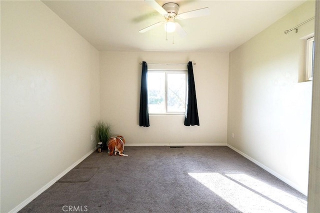 carpeted spare room with ceiling fan