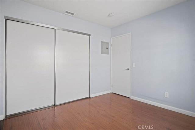 3738 Harrison St Unit 31, Riverside, CA 92503 - unfurnished bedroom featuring a closet, wood finished floors, visible vents, and baseboards