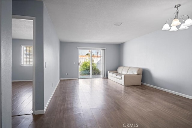 3738 Harrison St Unit 31, Riverside, CA 92503 - interior space featuring a wealth of natural light, an inviting chandelier, a textured ceiling, and dark wood finished floors