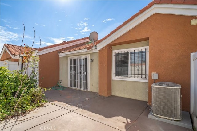 3738 Harrison St Unit 31, Riverside, CA 92503 - rear view of house with central air condition unit, a tile roof, a patio, and stucco siding