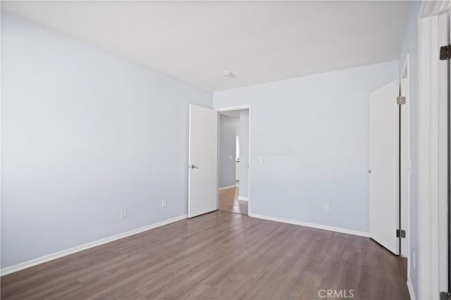 3738 Harrison St Unit 31, Riverside, CA 92503 - unfurnished room with baseboards and dark wood finished floors