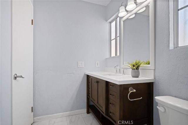 3738 Harrison St Unit 31, Riverside, CA 92503 - bathroom with baseboards, marble finish floor, vanity, and toilet