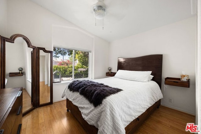 bedroom with lofted ceiling, light hardwood / wood-style floors, and ceiling fan